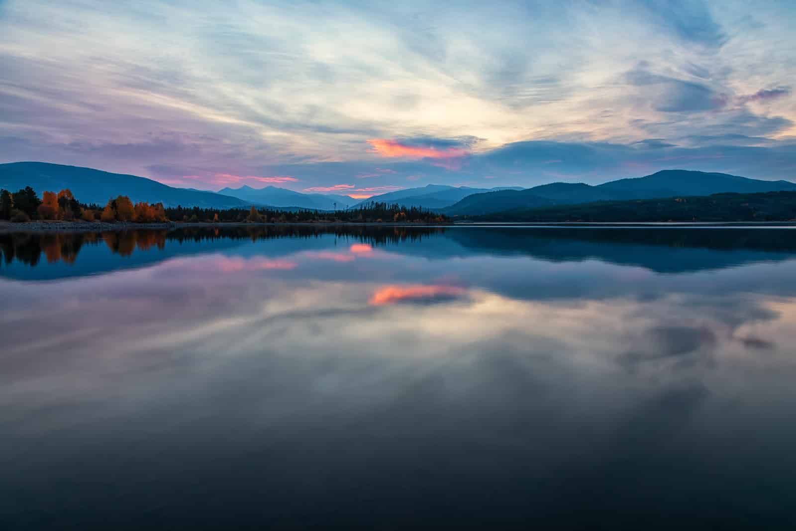 Frisco, Colorado — sunrise reflection over Dillon Reservoir with mountains in the background